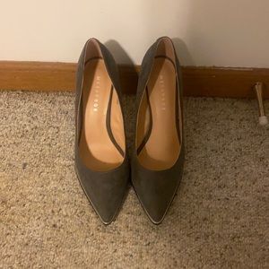 Dark grey heels have been worn